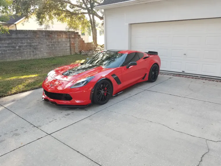 Red sports coupe in the driveway