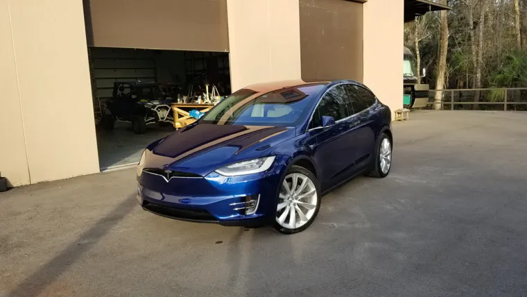 Blue Tesla in the driveway