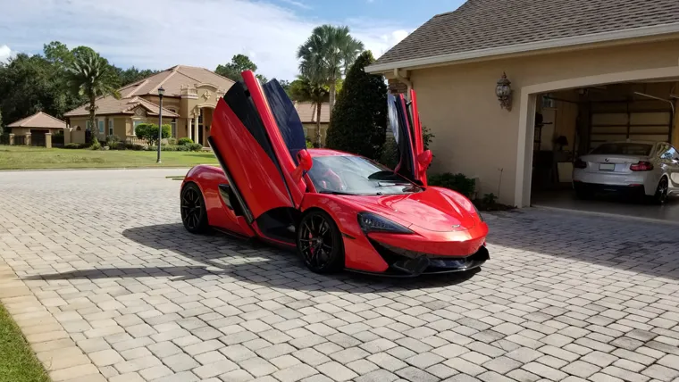 Red McLaren with open doors