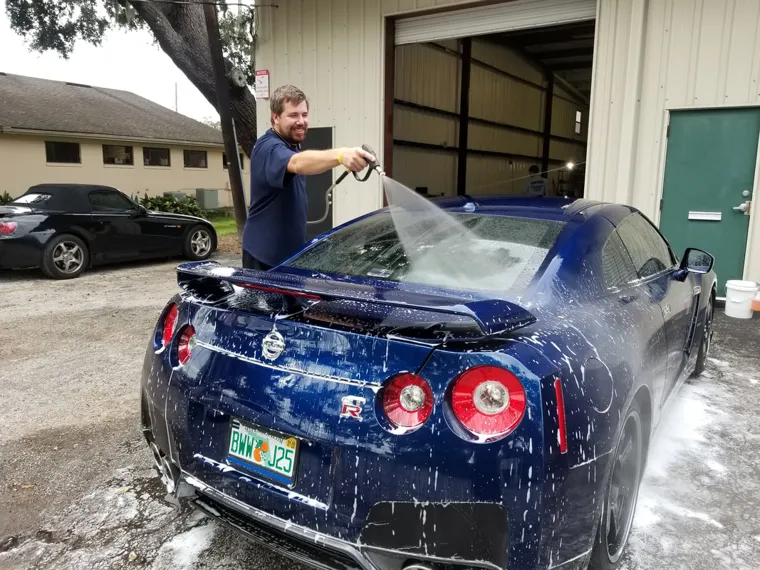 Rinsing a blue Nissan GT-R
