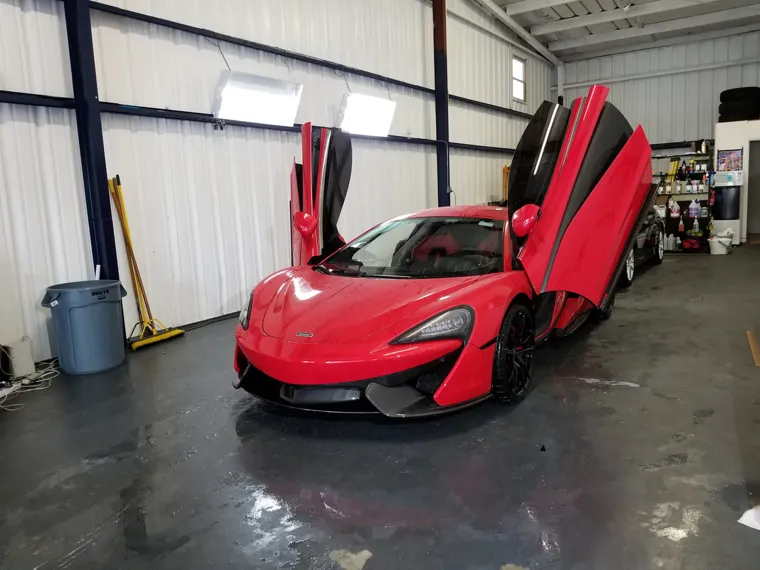 Red McLaren with its doors raised