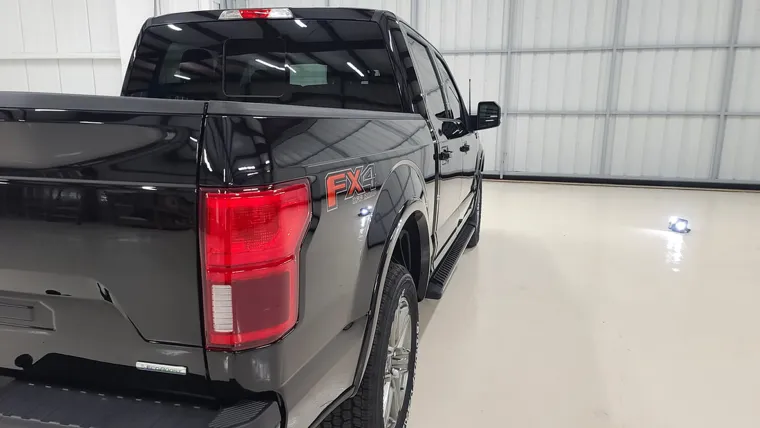 Black pickup in the hangar