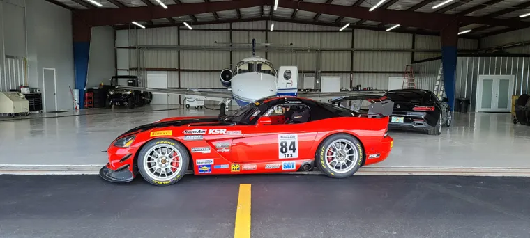 Red race car in the aircraft hangar