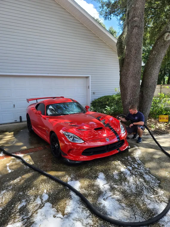Red sports car outside the studio