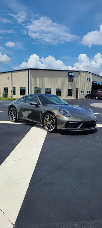 Silver sports car outside the hangar