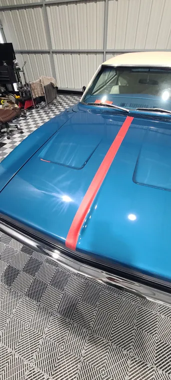 Blue classic car with racing stripes