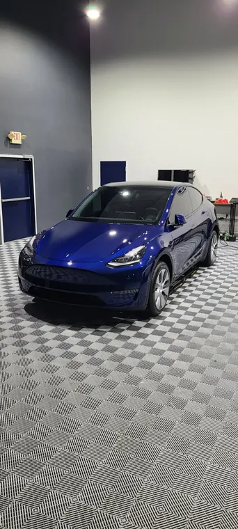 Blue sports car under studio lighting