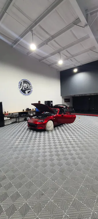 Red sports car inside the studio